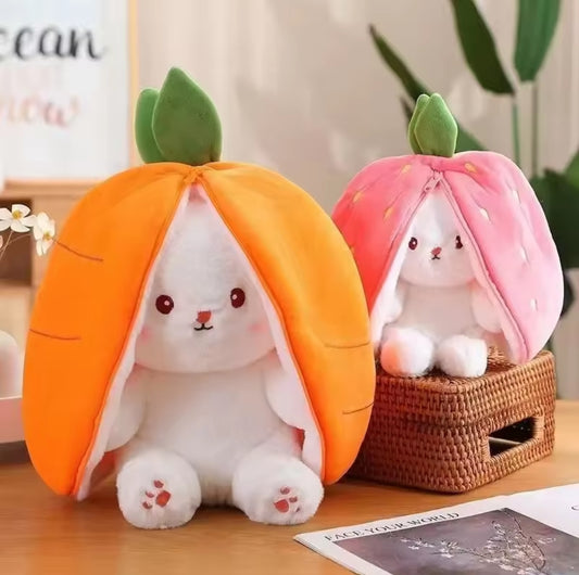 Reversible plush toy featuring a white bunny inside a carrot or strawberry shell; unzip to reveal the cuddly bunny with oversized ears.